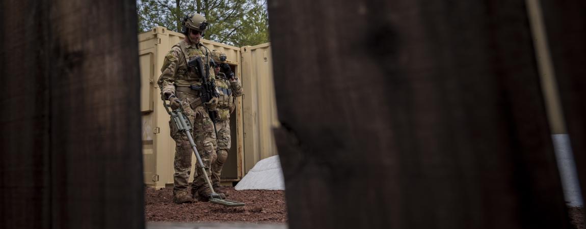  Civil Engineer Squadron Explosive Ordnance Disposal flight technician, sweeps for unexploded ordnance inside a mock village during a training scenario